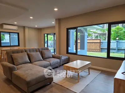 Spacious modern living room with large windows and garden view