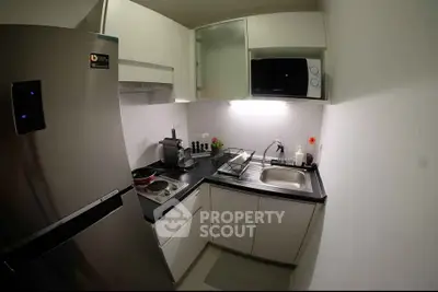 Modern compact kitchen with sleek appliances and efficient layout, perfect for urban living.