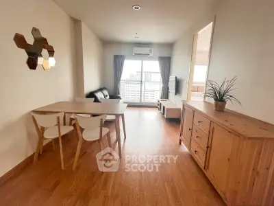Spacious living room with modern furniture and large window offering natural light.