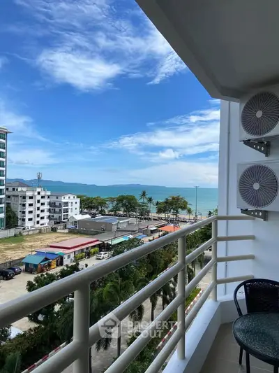 Stunning balcony view of ocean and cityscape with clear blue skies.