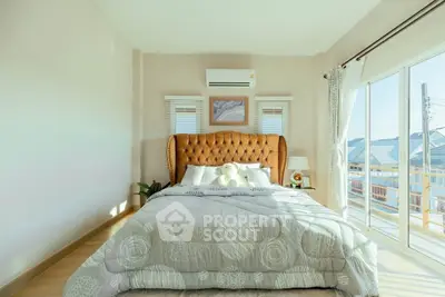 Bright and cozy bedroom with large windows and stylish decor