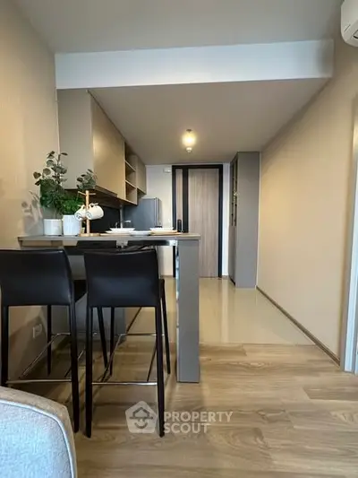 Modern kitchen with sleek design and open layout, featuring a stylish breakfast bar and contemporary decor.