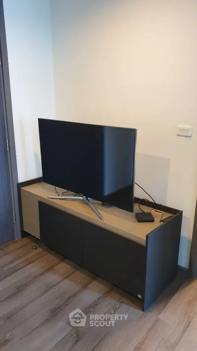 Modern living room with sleek TV unit and wooden flooring, perfect for cozy entertainment nights.