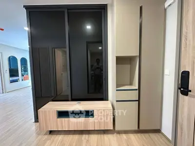 Modern living room with sleek storage and wooden flooring