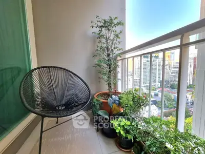 Charming balcony with city view, cozy chair, and lush potted plants, perfect for relaxation.