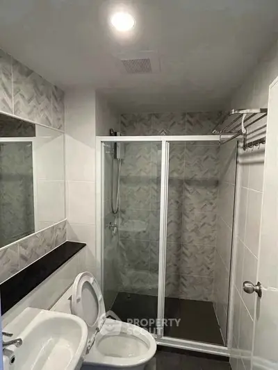 Modern bathroom with glass shower enclosure and sleek tile design