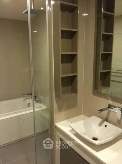 Modern bathroom with sleek sink and bathtub in elegant design.