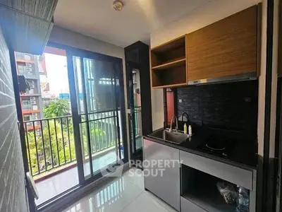 Modern kitchen with sleek design and balcony view in urban apartment
