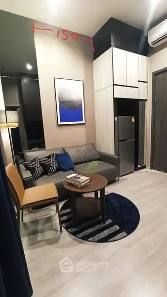 Modern living room with stylish decor and compact design, featuring a cozy sofa and chic furniture.