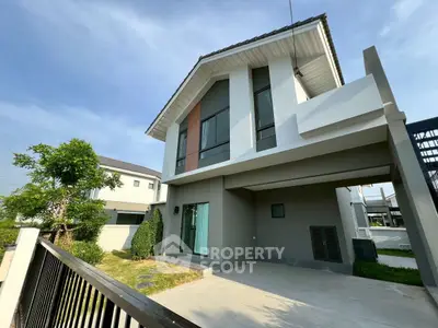 Modern two-story house with spacious driveway and contemporary design.