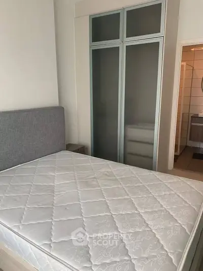 Cozy bedroom with modern wardrobe and comfortable bed in a stylish apartment.