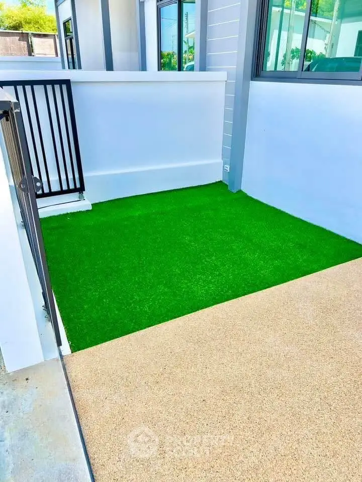 Charming small balcony with artificial grass and modern railing