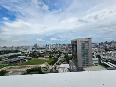 Stunning cityscape view from a high-rise building showcasing urban skyline and expansive sky.
