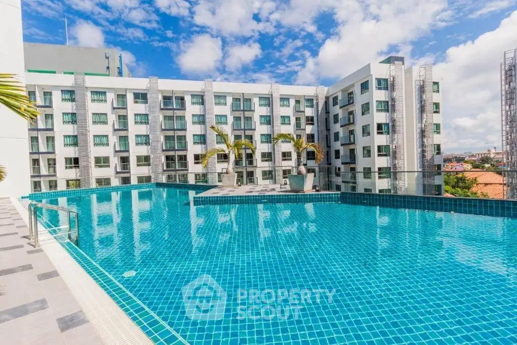 Luxurious apartment complex with stunning rooftop pool and modern architecture.