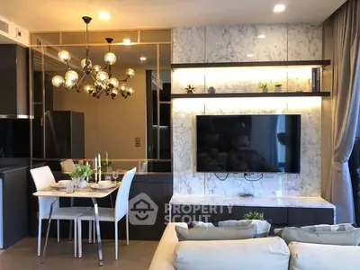 Modern living room with elegant dining area and stylish lighting fixtures.