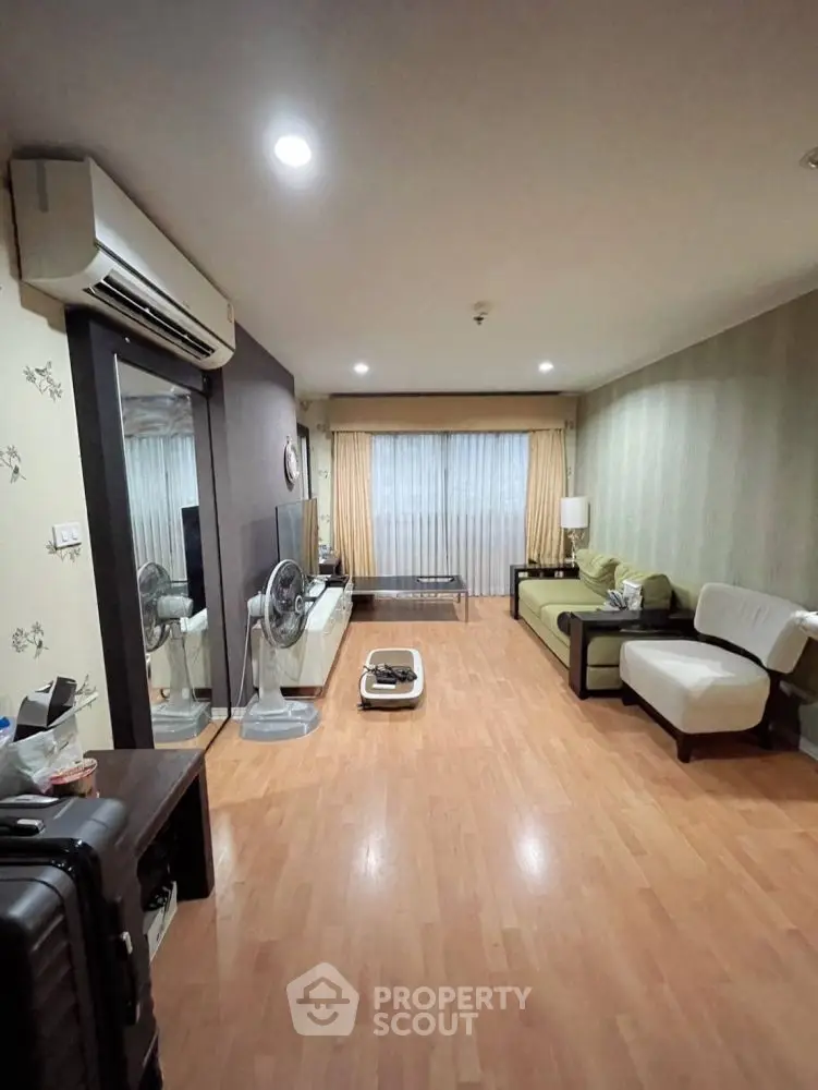 Spacious living room with modern decor and wooden flooring