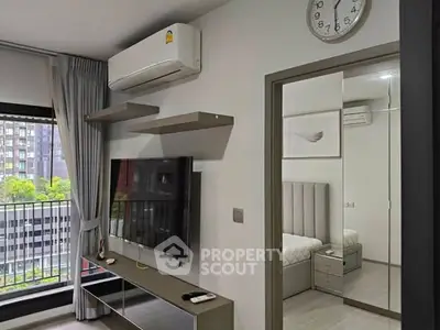 Modern apartment interior with sleek living room and cozy bedroom view.