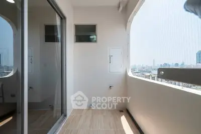 Spacious balcony with city view in modern high-rise apartment