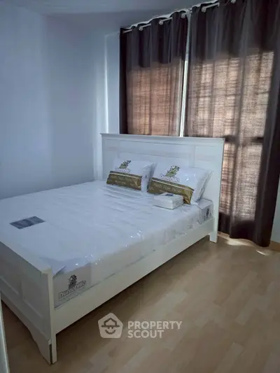 Cozy bedroom with natural light and modern furnishings, perfect for relaxation and comfort.