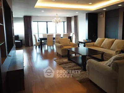 Spacious living room with elegant chandelier and modern furnishings