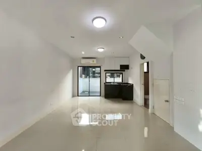 Spacious modern living room with open kitchen and sleek design