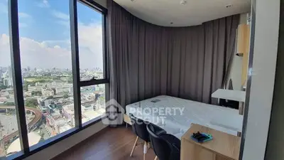 Modern bedroom with stunning city view from large windows, featuring sleek furniture and elegant design.