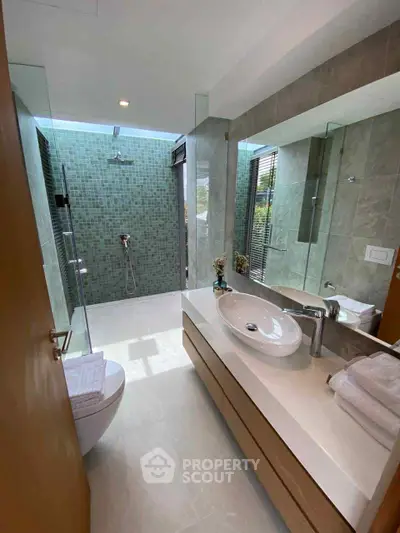 Luxurious modern bathroom with glass shower and elegant sink design