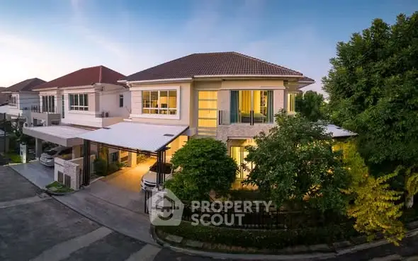 Stunning two-story house with modern design and lush greenery in a serene neighborhood.