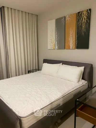 Cozy bedroom with modern decor and comfortable bed, perfect for relaxation.