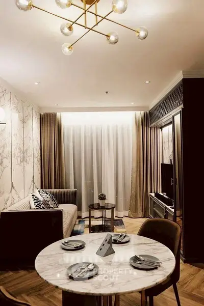 Elegant living room with modern decor and stylish lighting, featuring a cozy dining area and plush seating.