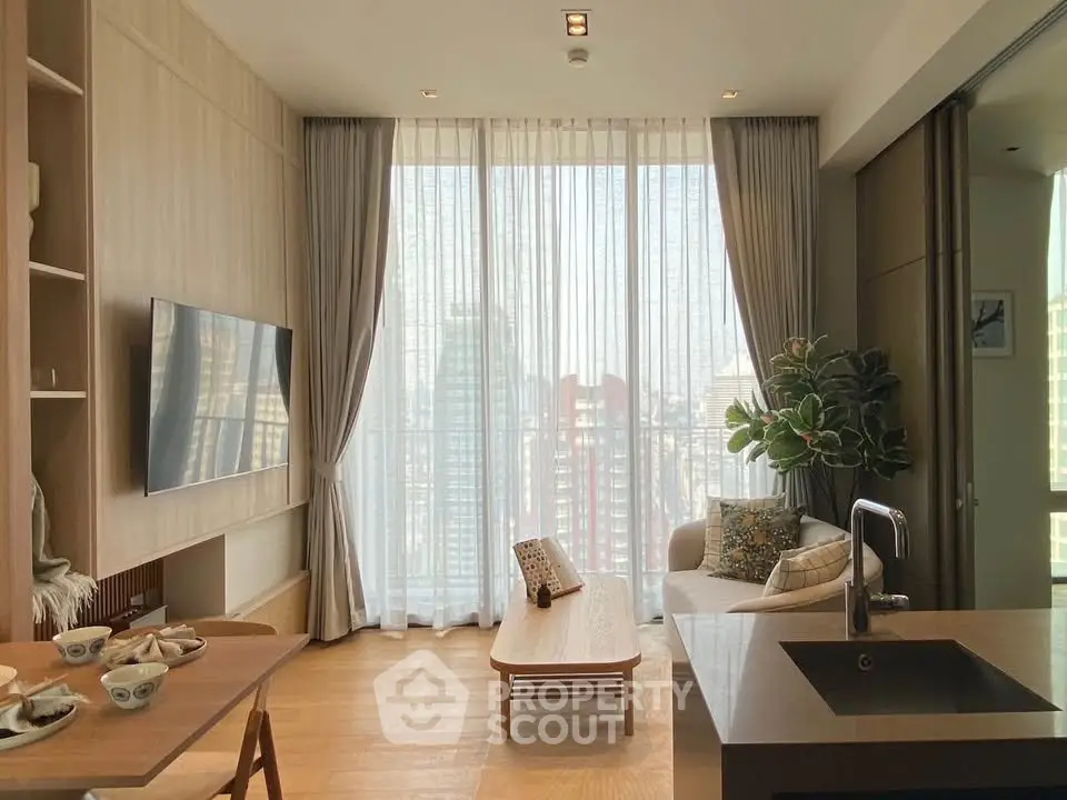 Modern living room with floor-to-ceiling windows and city view, featuring sleek furniture and open layout.