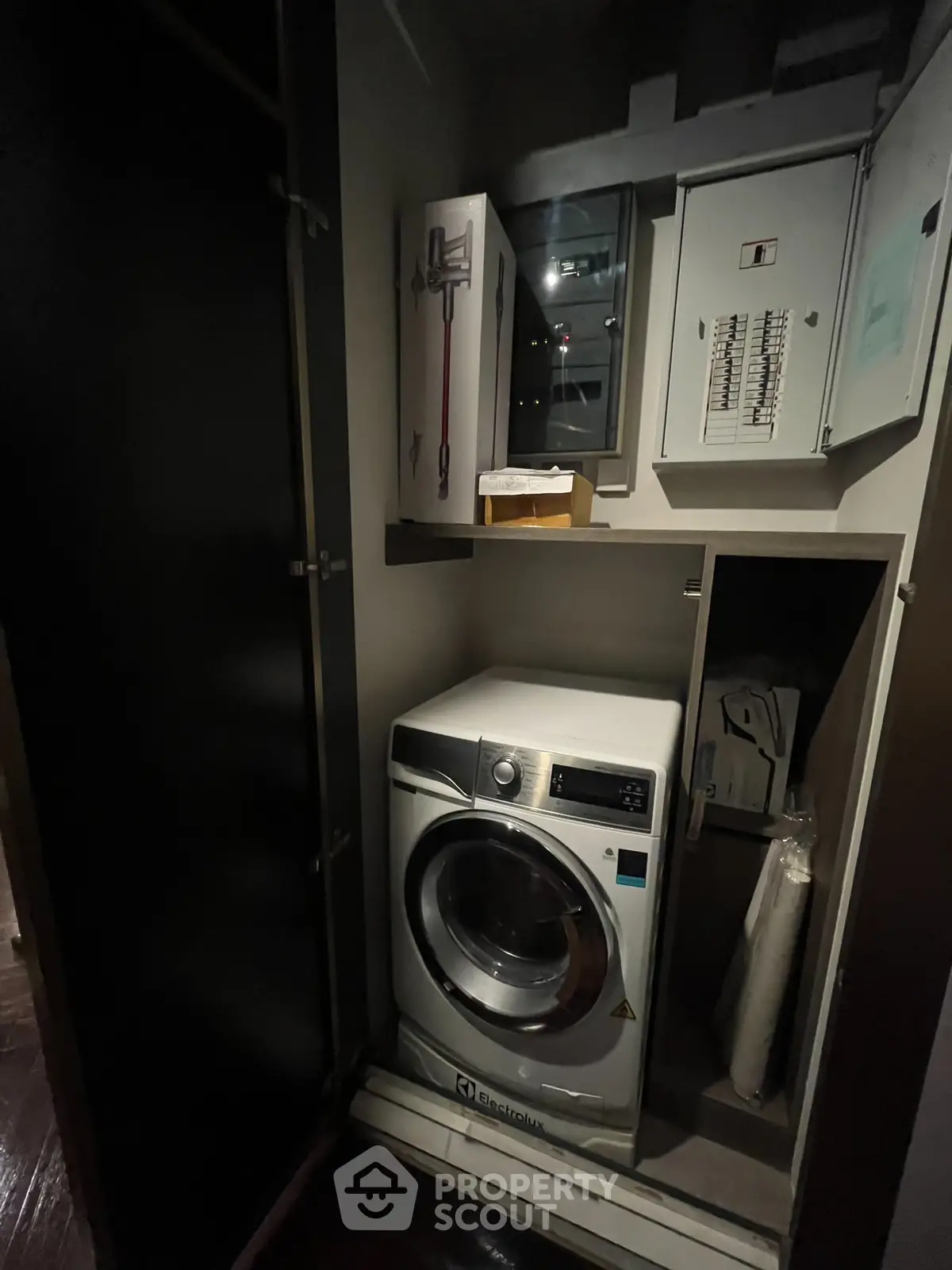 Compact laundry area with modern washing machine in a storage closet