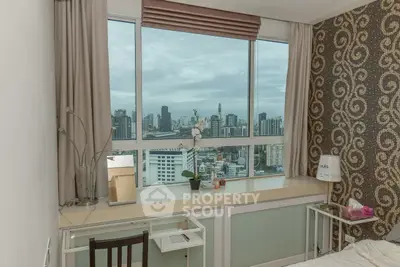 Chic bedroom with stunning city view, modern decor, and ample natural light.
