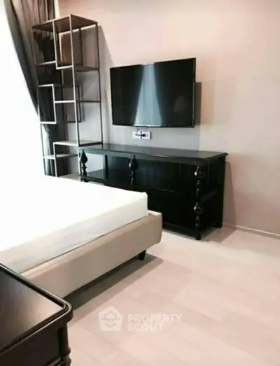 Modern bedroom with sleek TV setup and stylish furniture