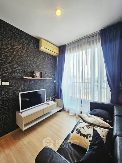 Modern living room with stylish decor, large window, and cozy seating area.