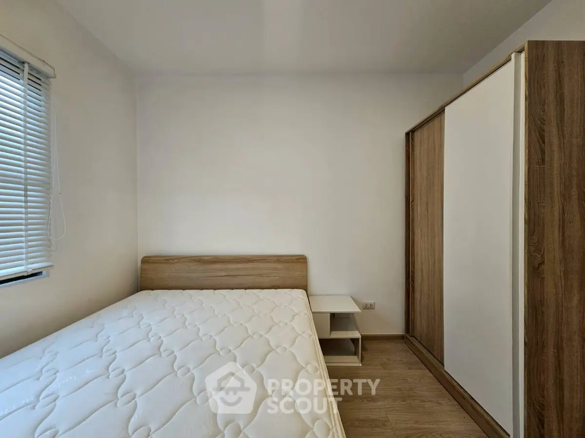 Minimalist bedroom with wooden furniture and natural light