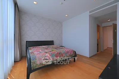 Spacious bedroom with elegant decor and large window for natural light