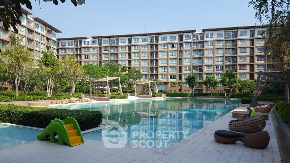 Luxurious apartment complex with serene pool and lush greenery