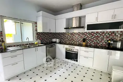 Modern kitchen with sleek white cabinets and stylish mosaic backsplash