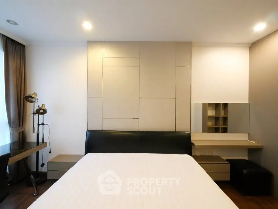 Modern bedroom with stylish decor and ample natural light