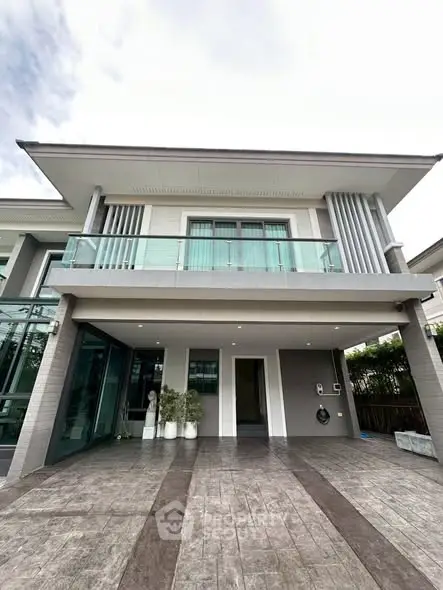 Modern two-story house with sleek design and spacious driveway