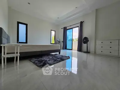 Spacious modern bedroom with large windows and minimalist decor