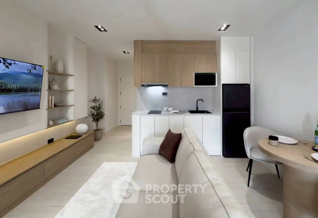 Modern living room with open kitchen, stylish decor, and cozy seating area