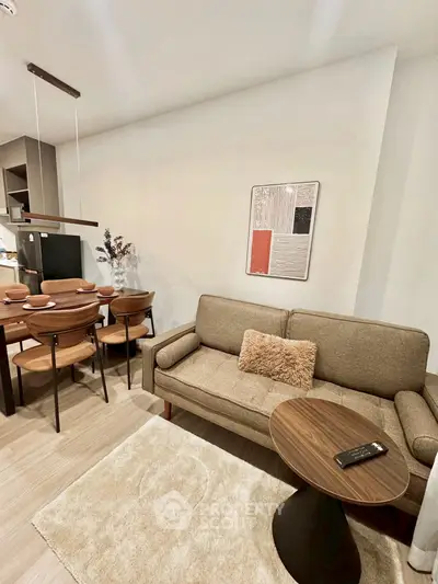 Modern living room with cozy sofa, dining area, and stylish decor in open layout apartment.