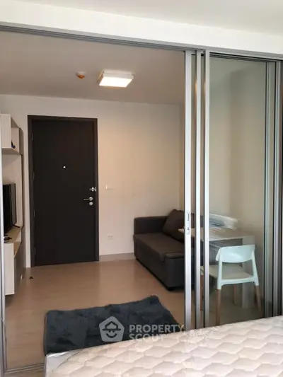 Modern studio apartment with sliding glass doors and cozy furnishings