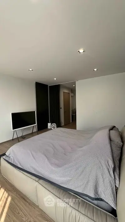 Spacious modern bedroom with stylish decor and natural light