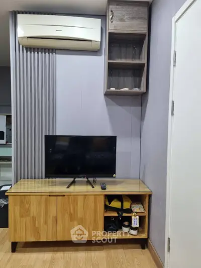 Modern living room with TV, wooden cabinet, and air conditioning unit