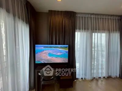 Stylish living room with large windows and modern TV setup