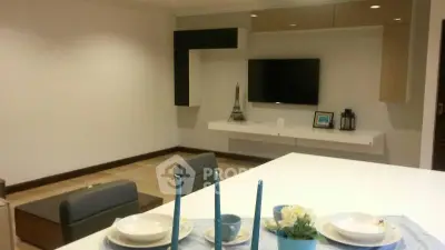 Modern living room with stylish decor and wall-mounted TV, perfect for relaxation and entertainment.