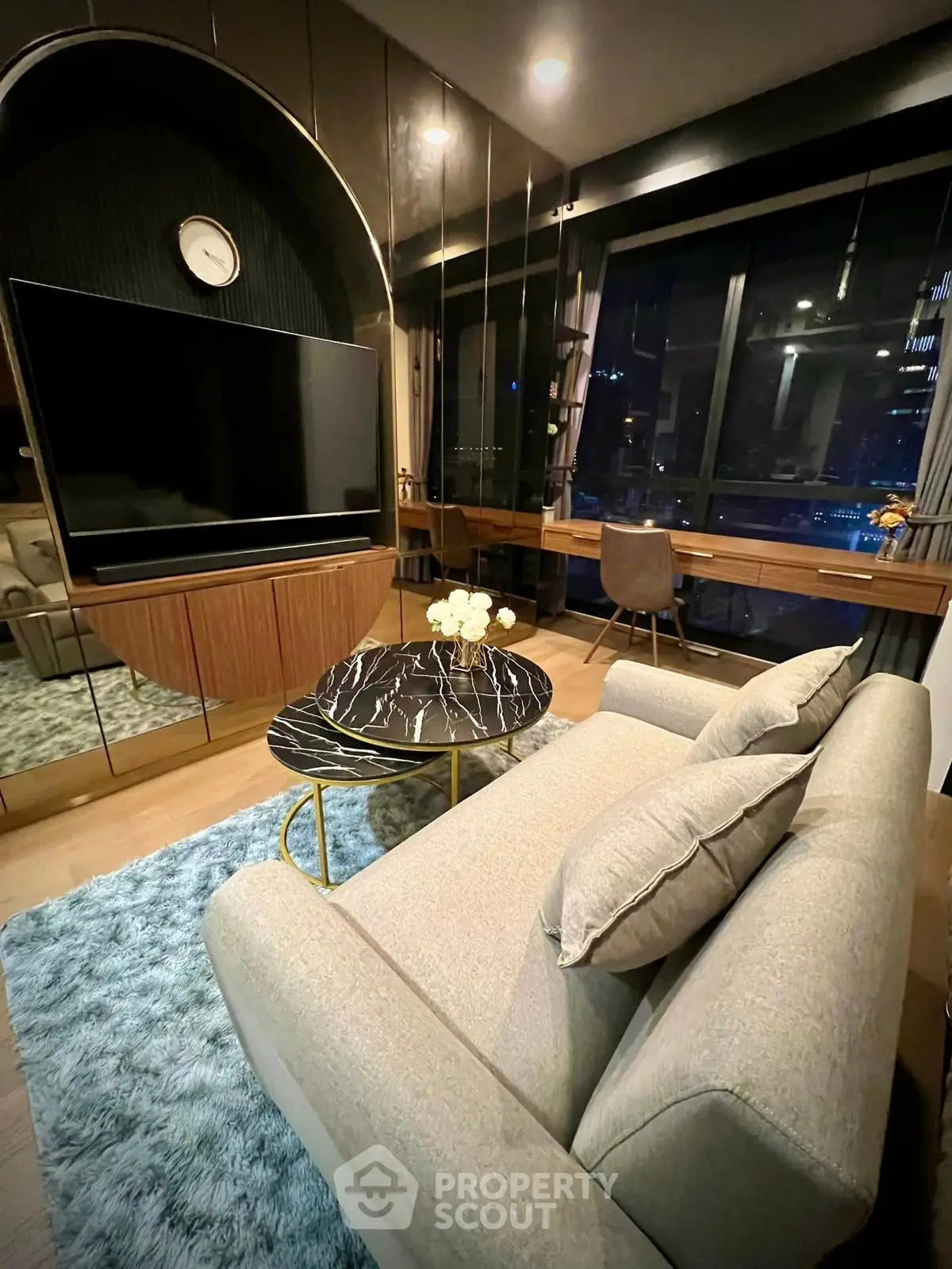 Luxurious modern living room with plush sofa and stunning city view.